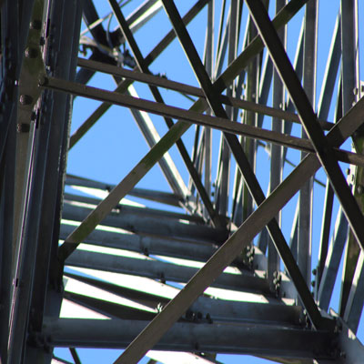 An image of a power tower taken from a worm's eye view 